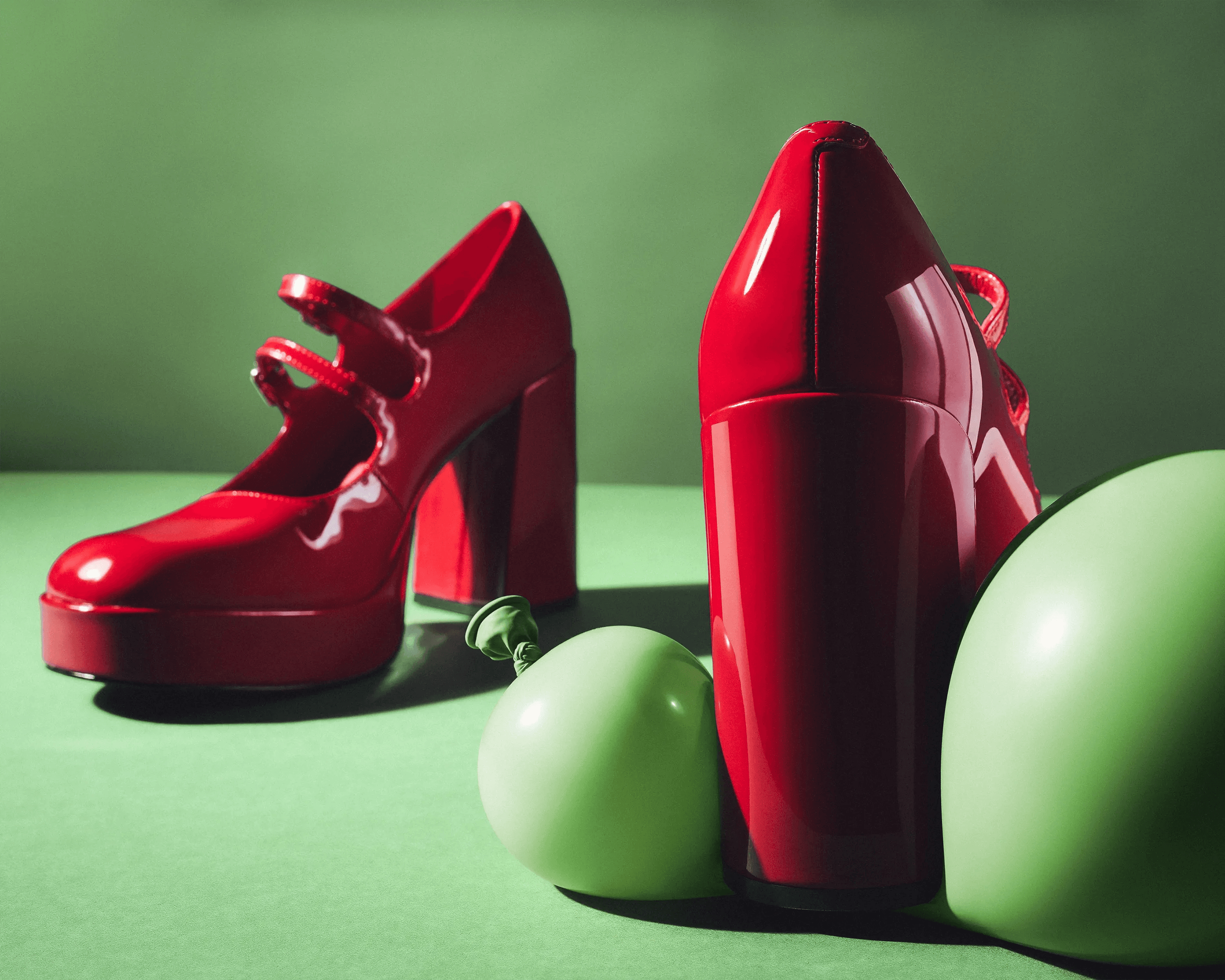 Steve Madden shoes styled with green balloons against green backdrop, colour contrast still life photography London