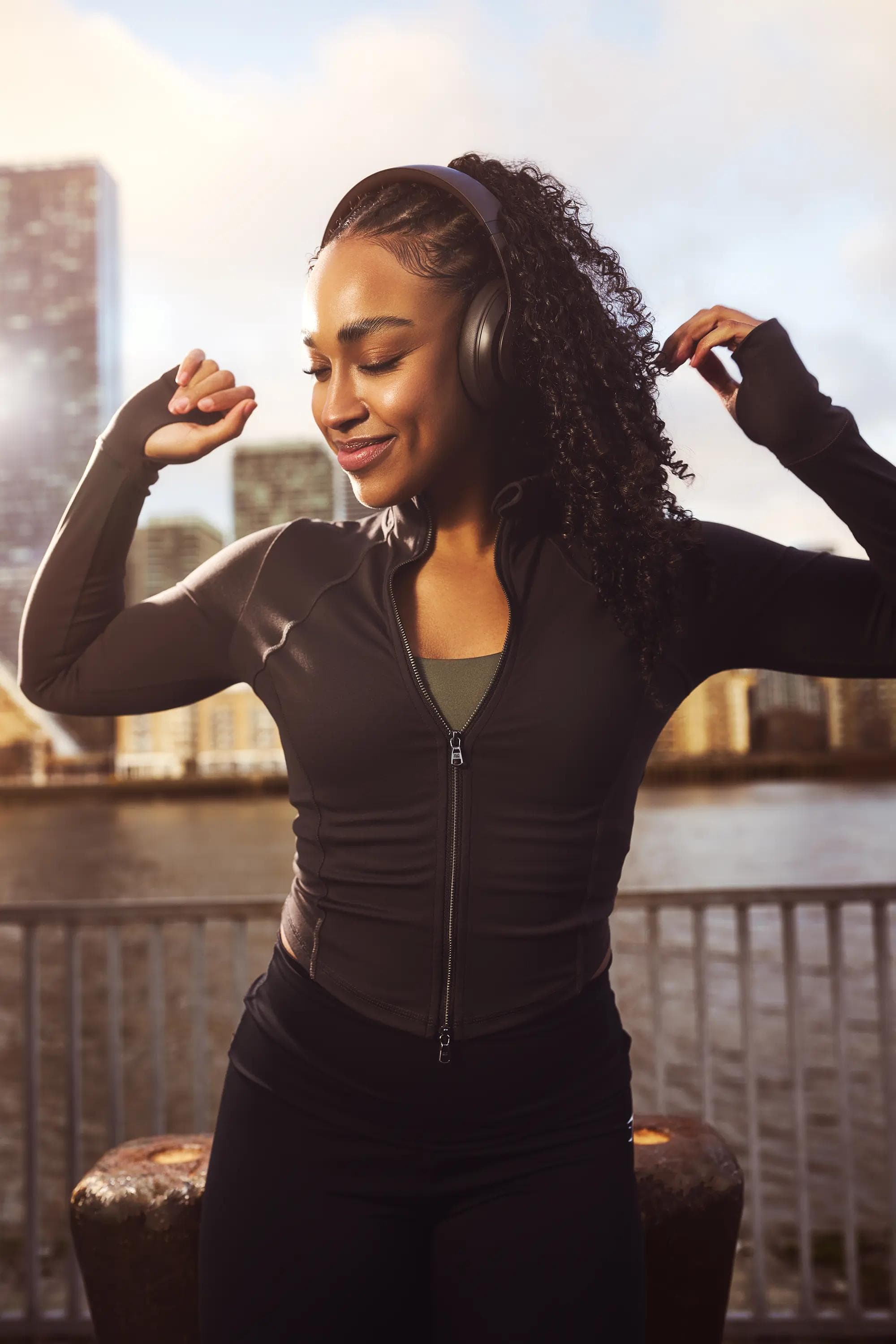 woman dancing wearing headphones outdoor London lifestyle photography