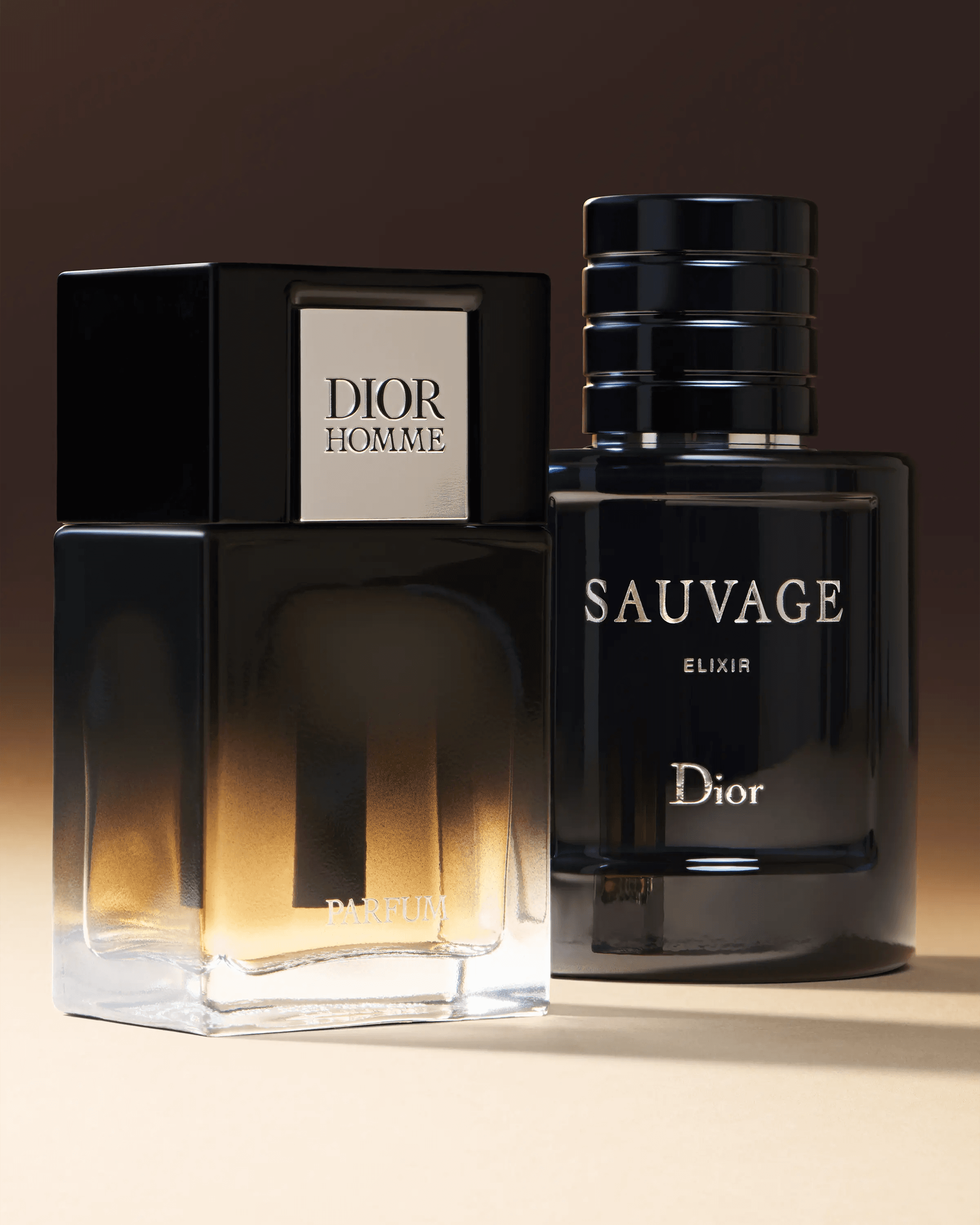 Dior Homme Parfum and Sauvage Elixir bottles against dark warm gradient, luxury menswear fragrance still life photography London