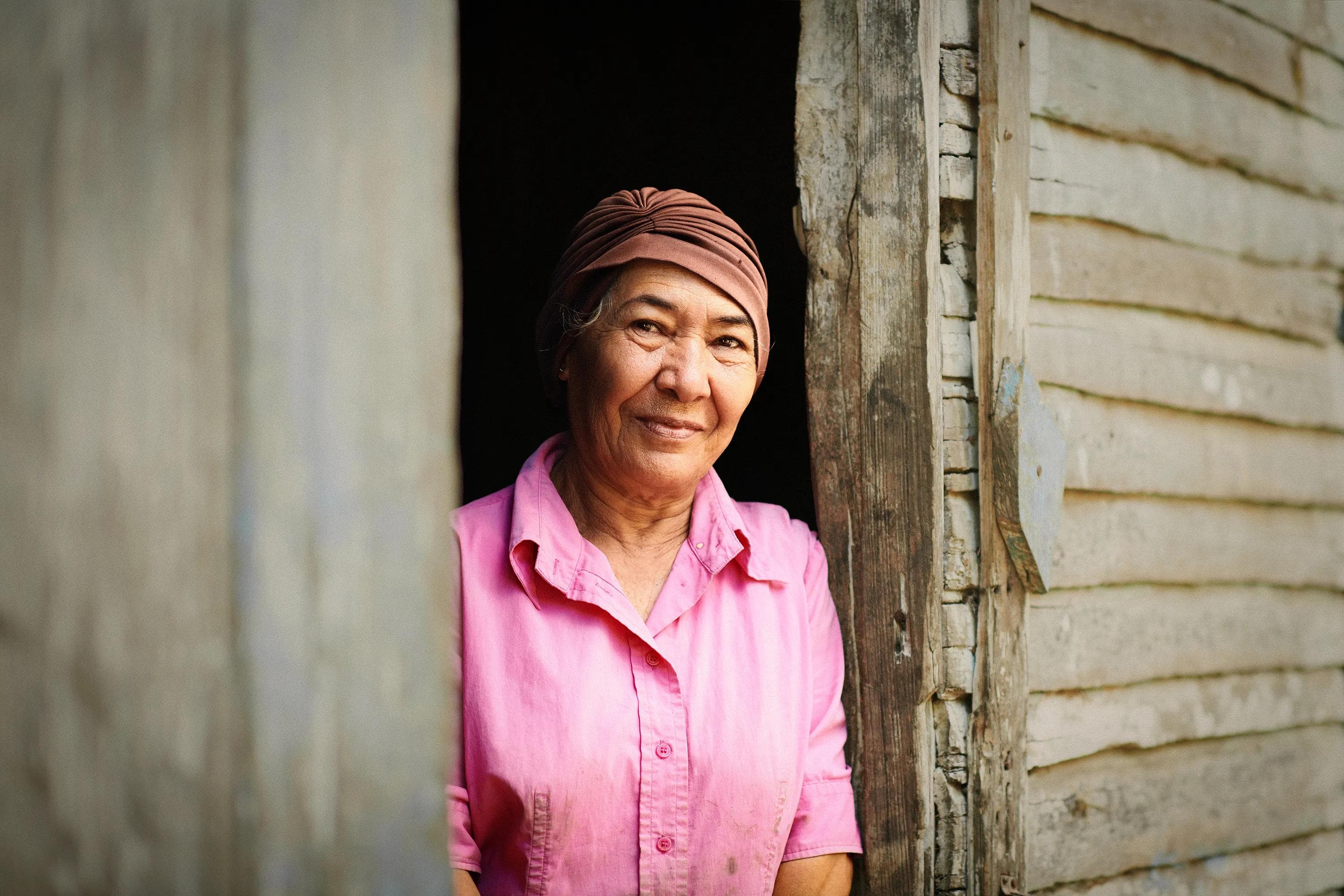 woman inside small local shop surrounded by products and shelves, documentary portrait photography Dominican Republic