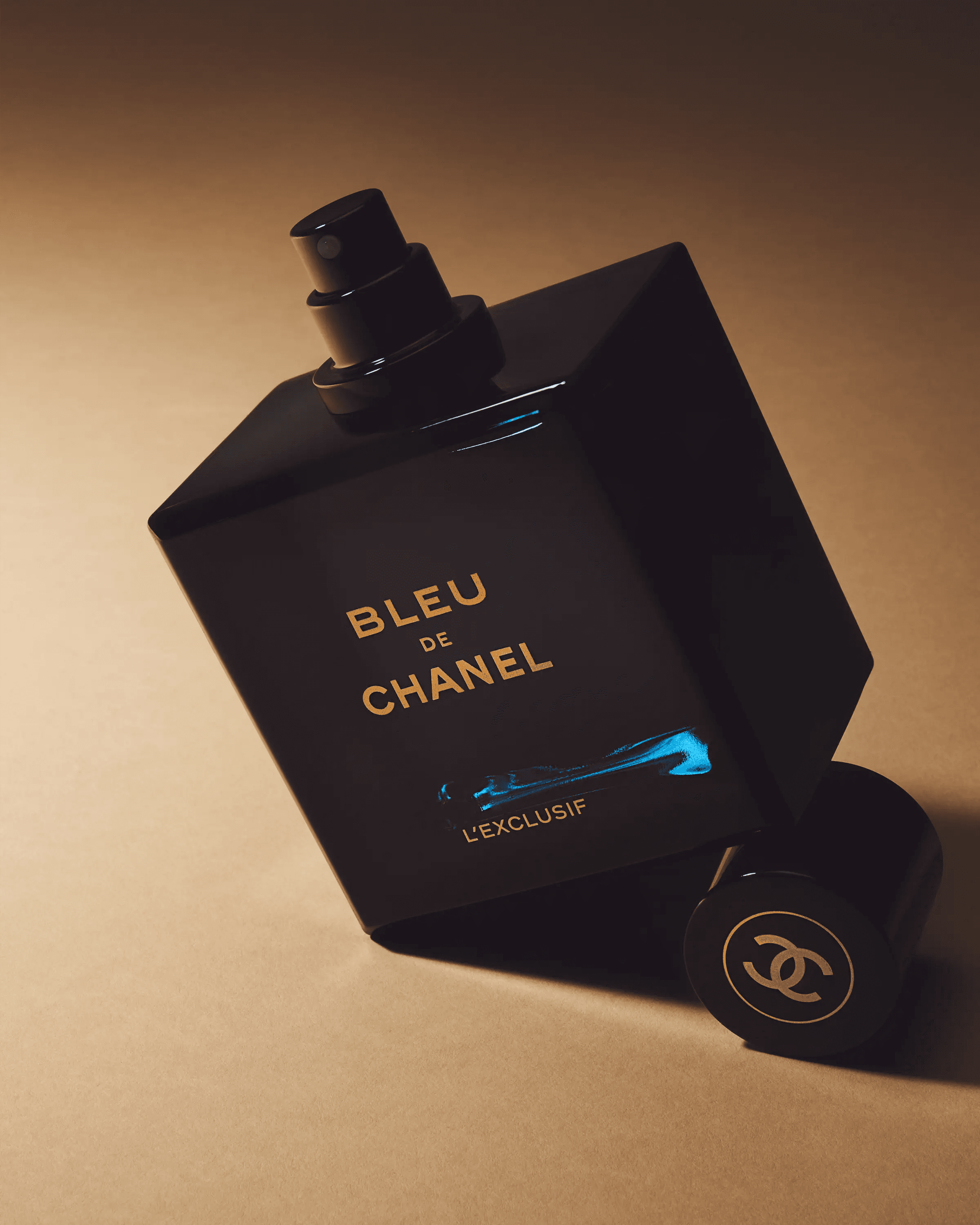Chanel Chance Eau Splendide bottle tilted on warm beige surface casting long directional shadow, luxury fragrance still life photography London