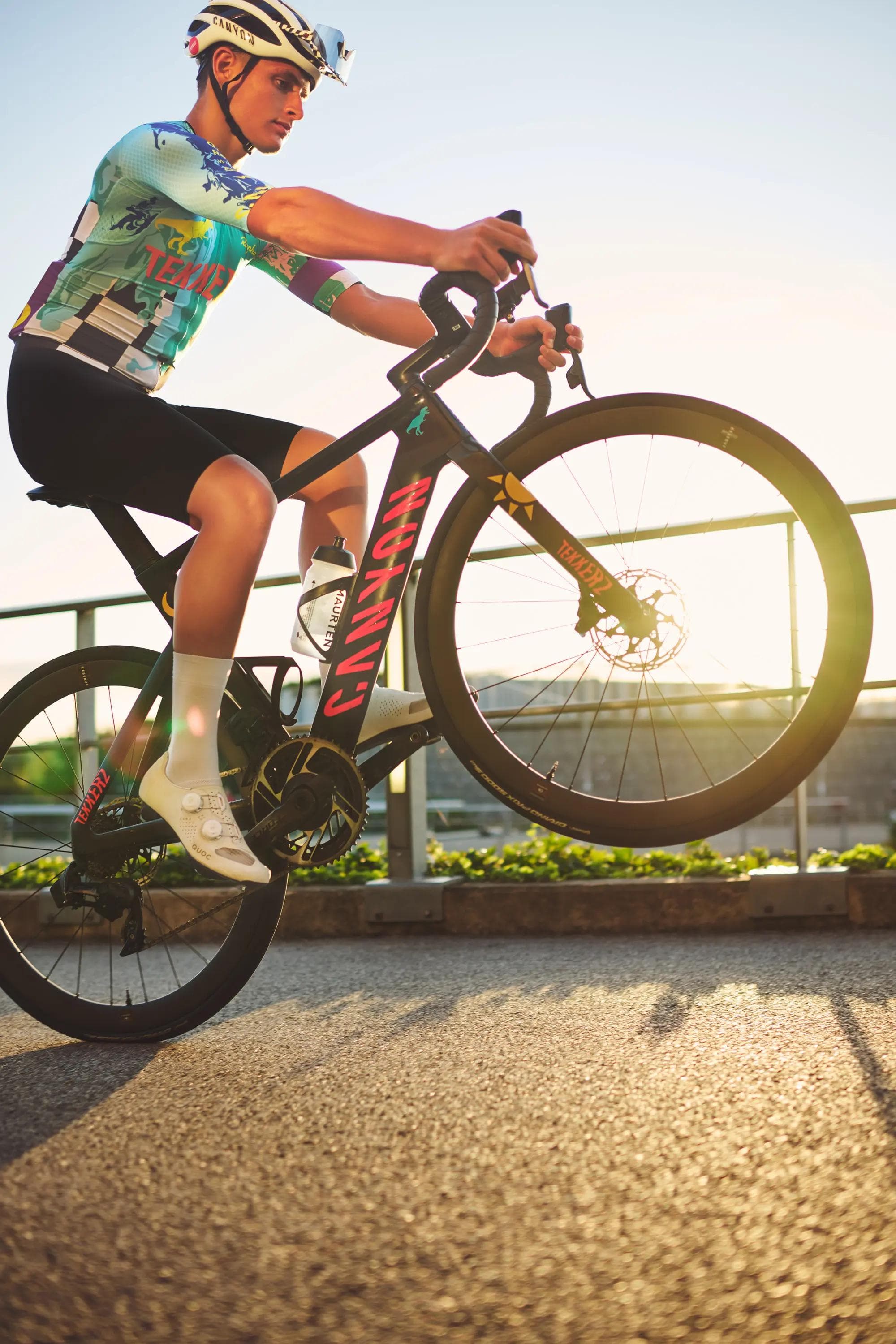 cyclist riding fast with motion blur near modern building, dynamic movement, cycling photography London