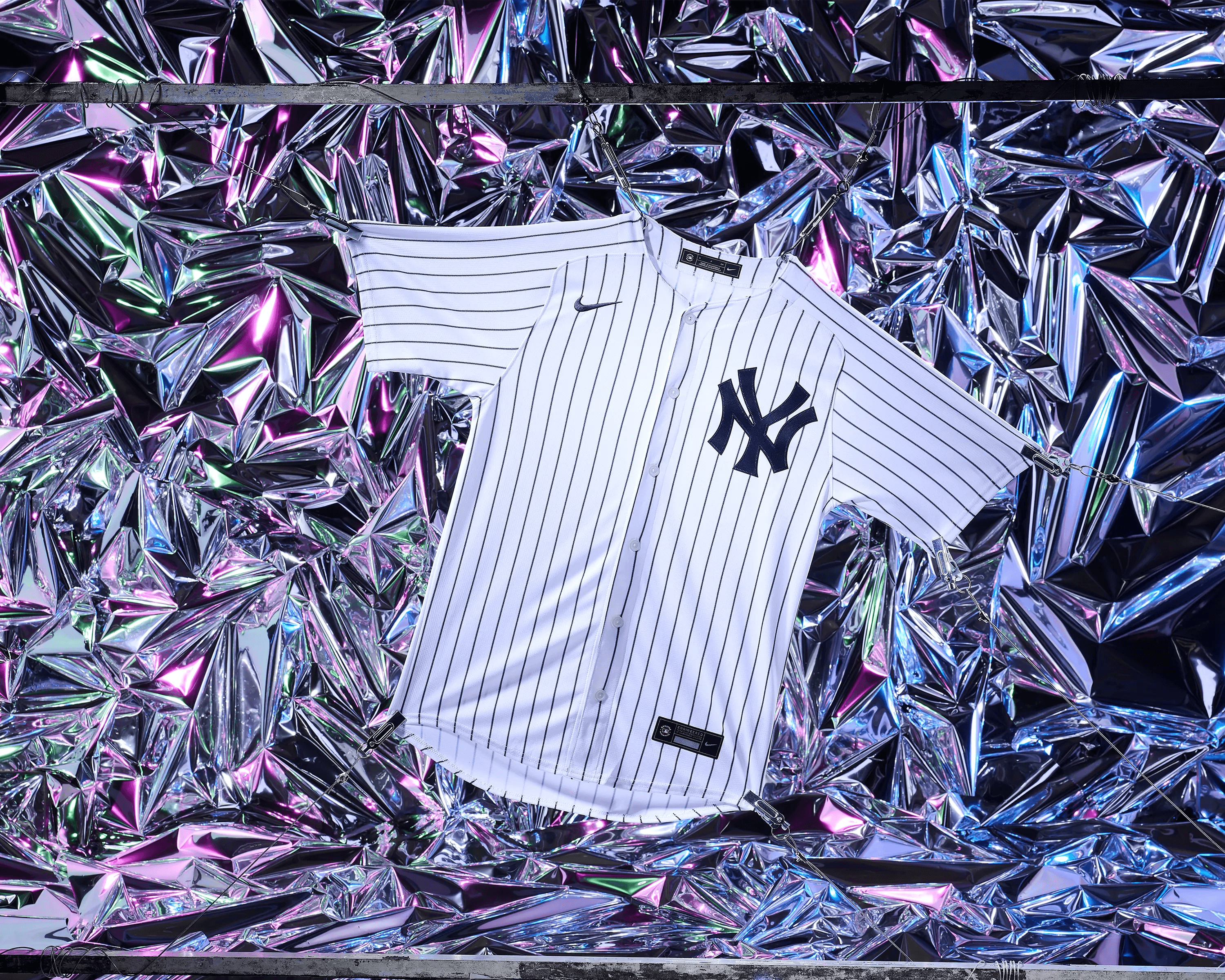 PSG home kit centred against full holographic silver and pink backdrop, Christmas campaign still life photography Manchester