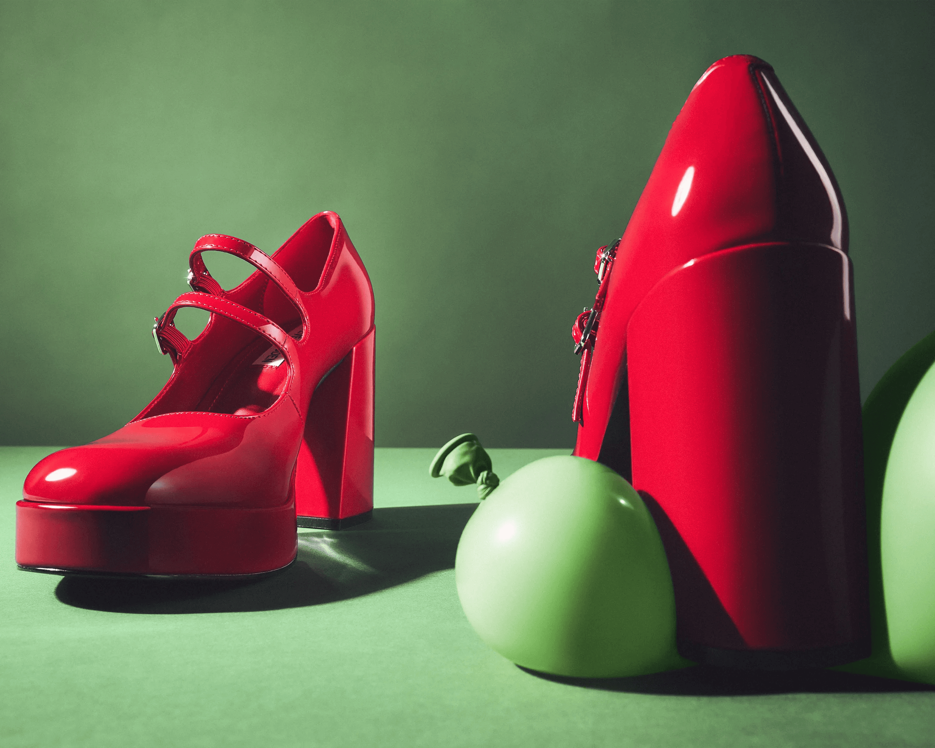 Steve Madden red patent shoes arranged with balloons in red colourway, editorial product photography London