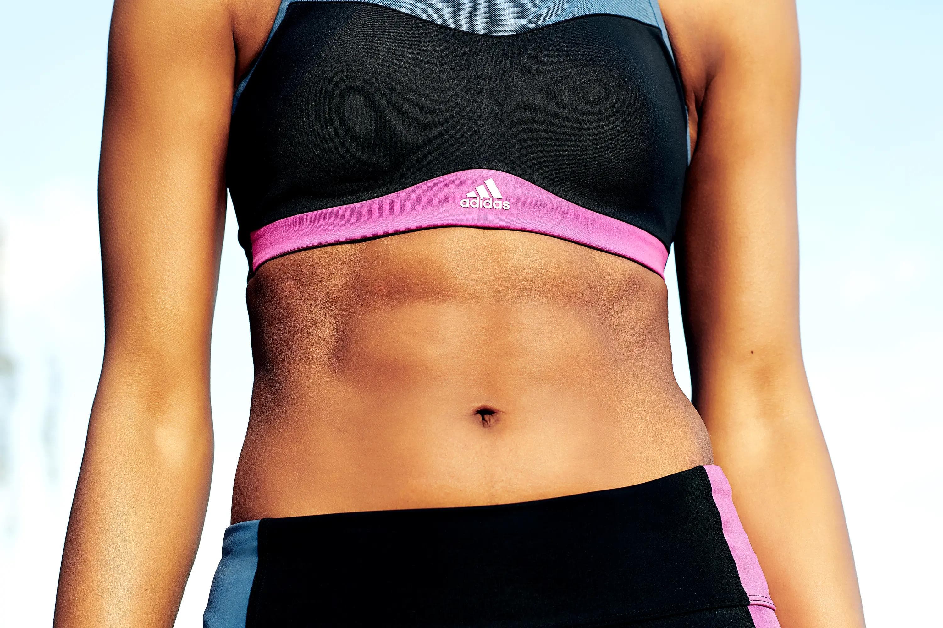close up crop of adidas sports bra and training apparel highlighting athletic physique and garment details