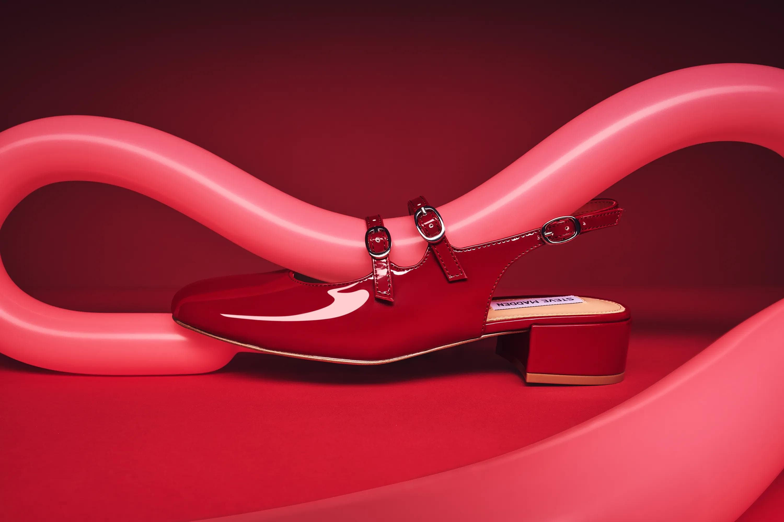 red patent Steve Madden Mary Jane shoes styled with red balloons against red studio backdrop, still life product photography London