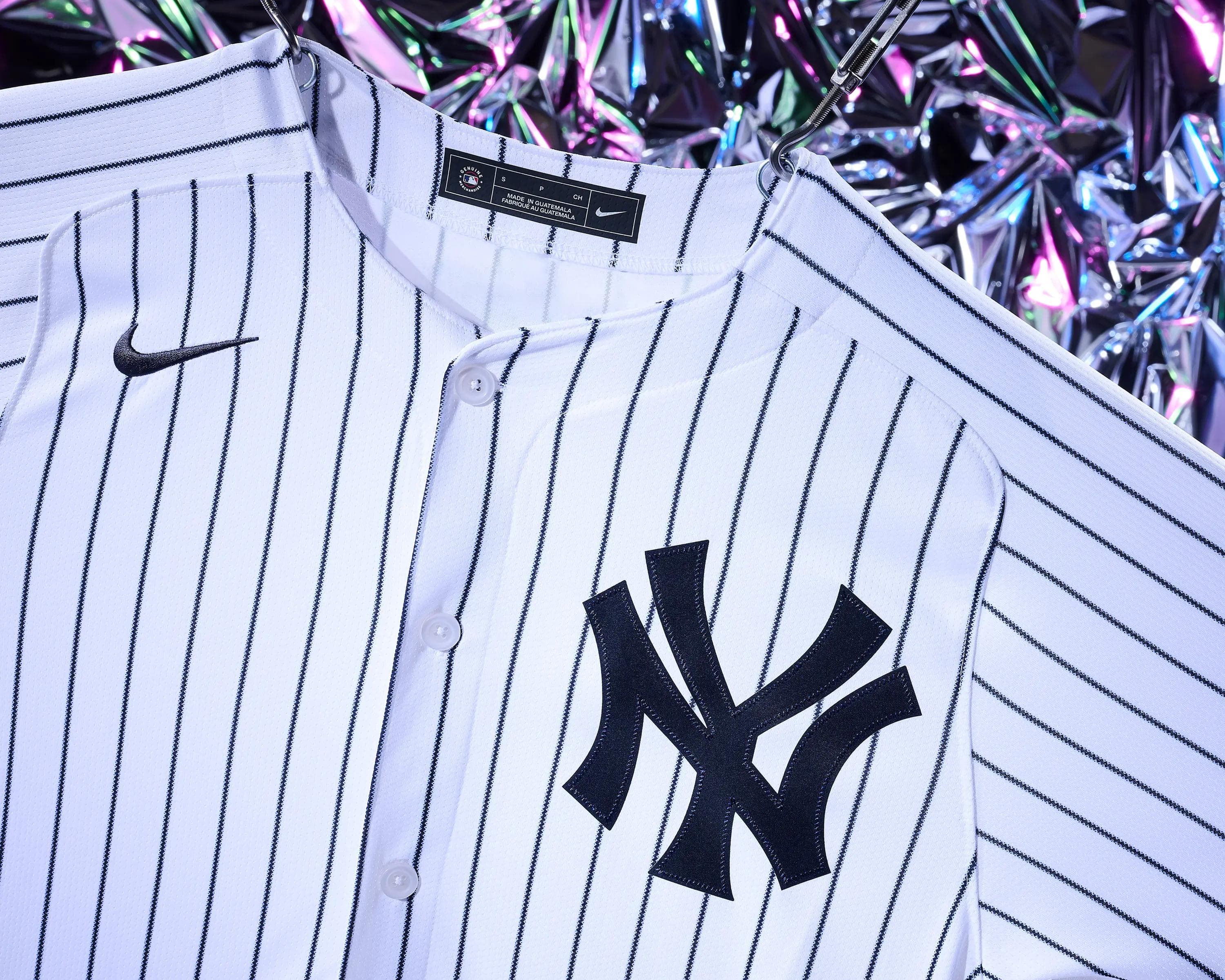New York Yankees pinstripe baseball jersey suspended against holographic backdrop, commercial sportswear still life photography Manchester